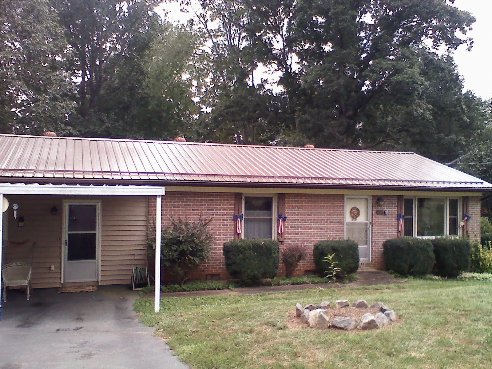 Bronze metal roof and carport on a brick ranch home — Roof Repair work by our crew in Riverside